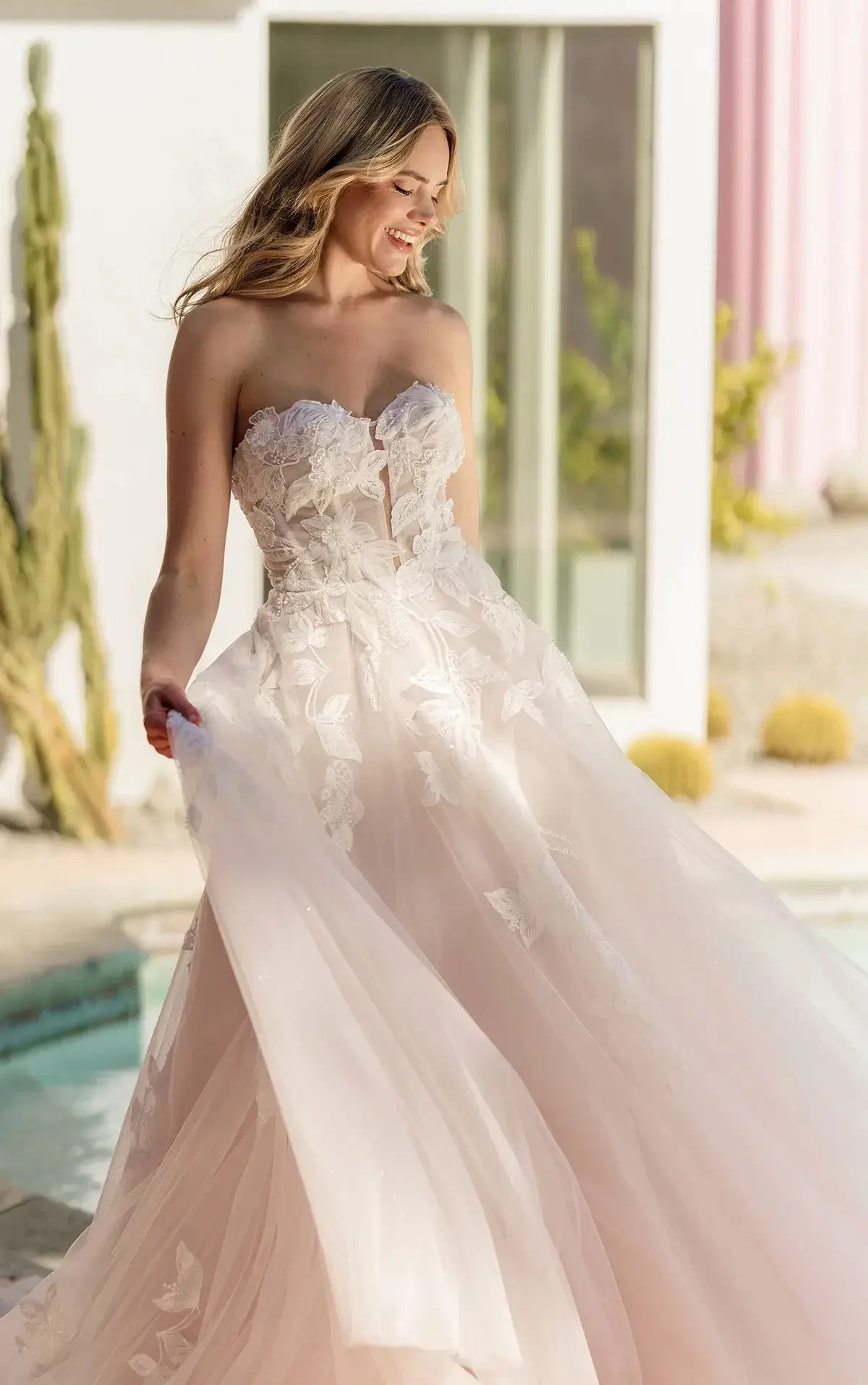 model is wearing a strapless lace a-line wedding dress